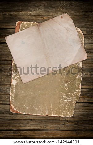 Blank old paper sheets on wood