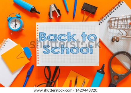 Creative flat top view of the position of school supplies stationery, education elements on an orange background. Concept back to school template for your text or design.