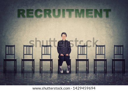 Young woman sitting on a chair as perfect candidate for a vacant job place waiting to be hired. Business career development concept, job recruitment and employment. Human resources management choice.