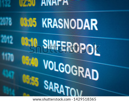 Electronic scoreboard flights and airlines. Destinations: Simferopol, Volgograd, Krasnodar, Saratov. Airport flight information arrival displayed on departure board, flight status changing