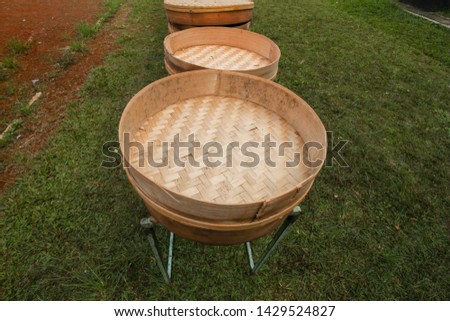 Tampah is a circular tool made of woven hemispheres of split bamboo trees