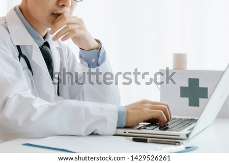 Male doctor use computer,research and analyze,Disease analysis,and record patient information,Concept using technology for medical benefits and data collection