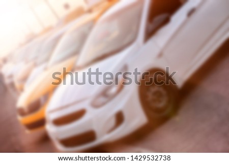 taxi car on parking waiting for passenger on sunset blur background street view of modern city yellow and white cab parked in line public town transportation abstract off level blurred concept