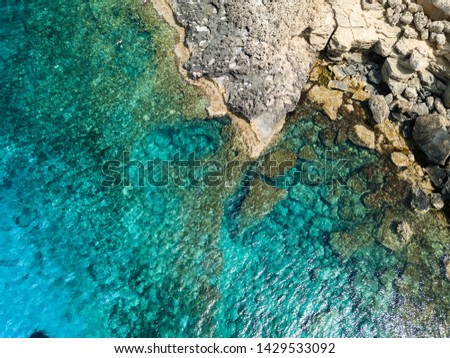 Top view aerial photo from flying drone of Indian Ocean seashore with beautiful color sea waves. Wonderful seascape with copy space for advertising text message. Perfect background for travel website