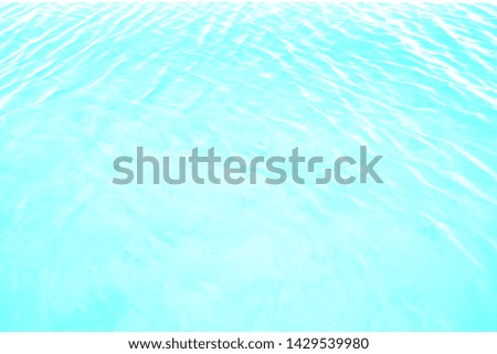 Blurred focus of water motion background. Top view of beautiful swimming pool with clear water in blue and turquoise color in the morning. 