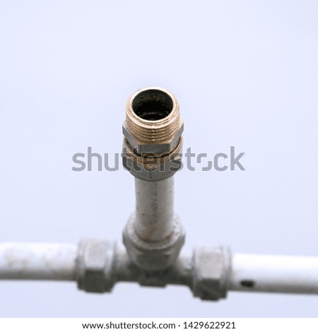 Old connection fitting tee on plastic water pipes