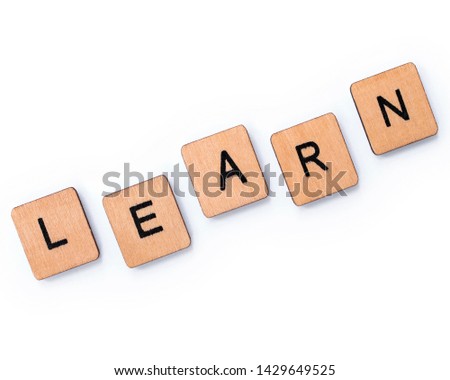 The word LEARN, spelt with wooden letter tiles over a white background.