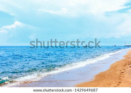 Calm blue mediterranean sea and a yellow sand