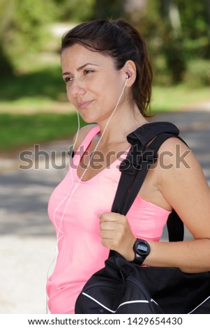 pretty sporty woman after jogging in park