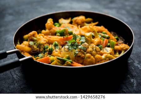 Mix vegetable curry - Indian main course recipe contains Carrots, cauliflower, green peas and beans, baby corn, capsicum and paneer/cottage cheese with traditional masala and curry, selective focus Royalty-Free Stock Photo #1429658276
