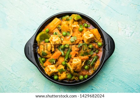 Mix vegetable curry - Indian main course recipe contains Carrots, cauliflower, green peas and beans, baby corn, capsicum and paneer/cottage cheese with traditional masala and curry, selective focus Royalty-Free Stock Photo #1429682024