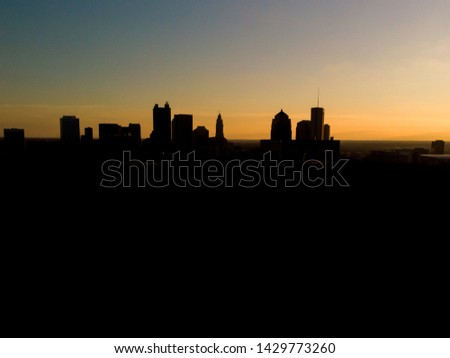 Columbus, Ohio downtown at sunset with the city silhouetted.