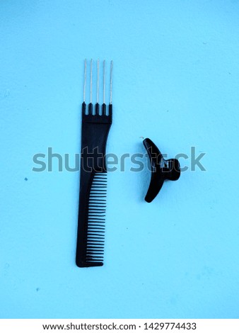 Black styling tools on the blue background 