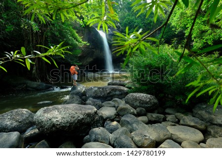A photographer in the beautiful waterfall,hew su wat waterfall in khao yai national park thailand