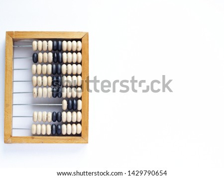 Education, training and account concept.Teaching children to count. Vintage wooden abacus isolated on white background.close up. Top view with copy space for text. Royalty-Free Stock Photo #1429790654