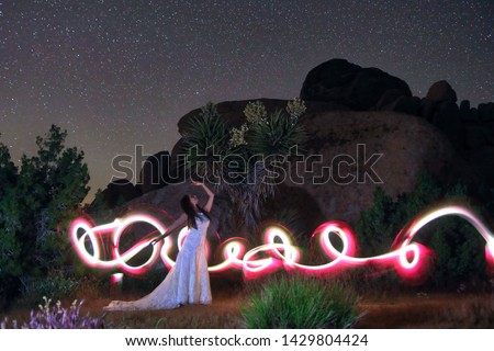Girl Light Painted in the Desert Under the Night Sky