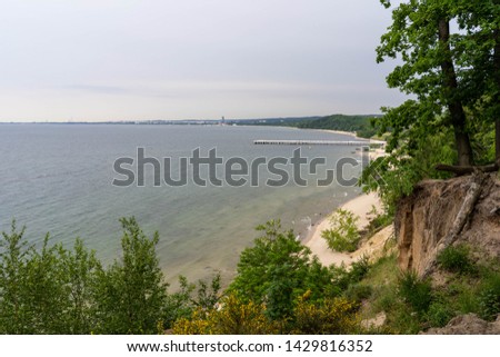 Gdynia cliff at Poland and scenery to Sopot and Gdansk, captured with full frame camera, capturing the drop and height of the cliff. Sunny day , waves on the beach.