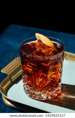 Negroni, an italian cocktail, an apéritif, first mixed in Firenze, Italy, in 1919. Count Camillo Negroni asked to strengthen his Americano by adding gin rather than normal soda water. Royalty-Free Stock Photo #1429822127