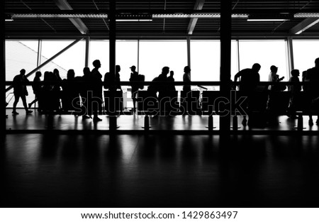 Passengers boarding plane in Schipol airport terminal