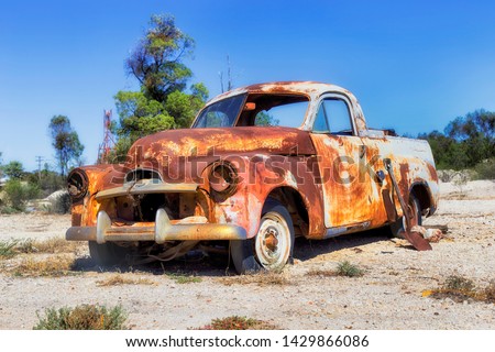 Old abandoned rusty car for scrap metal on grounds of remote outback Lightning ridge town - centre of Australian opal mining.