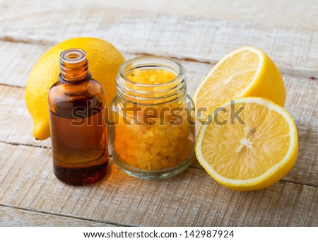 Essential aroma oil with lemon on wooden background. Spa products.  Selective focus.