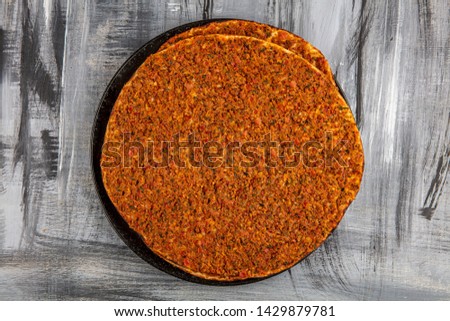 Turkish pizza with meat - lahmacun macro on a wooden table. Horizontal 