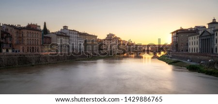 Long exposition and glowy photography of Ponte Vecchio at sunset in Florence, Italy. Wide panoramic photo, can be used as web banner