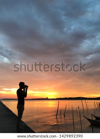 shadow photographer background of sunset at sea