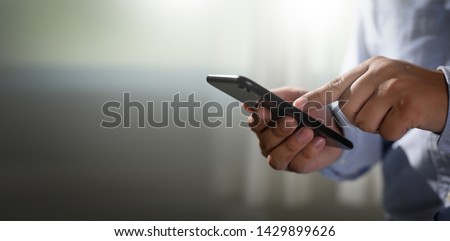 man holding en hands and using digital tablet  Mobile Phone telephone with blank copy space scree