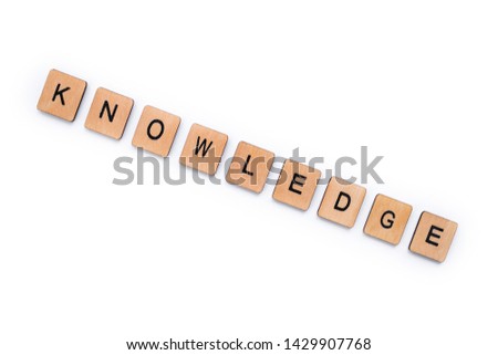 The word KNOWLEDGE, spelt with wooden letter tiles over a white background.