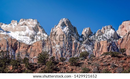 A panoramic view of the majestic mountain ranges at Zion National Park in Springdale, Utah, United States shot during the middle of the day. 