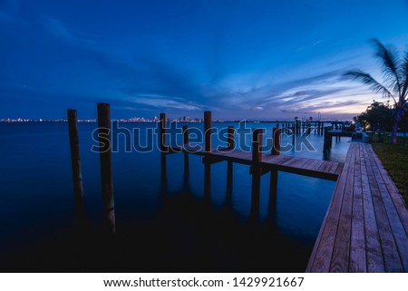 Private dock, with Miami Skyline as backdrop. during dusk