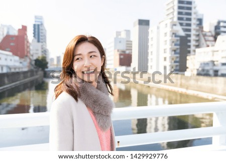 young attractive asian woman in a coat