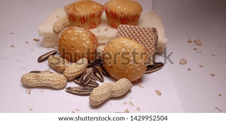 this is a picture of cakes, wafers, bread, 
sunflower seeds and  peanuts.