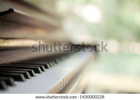 Piano with blurred green background