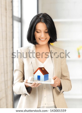 picture of woman holding tablet pc with house illustration