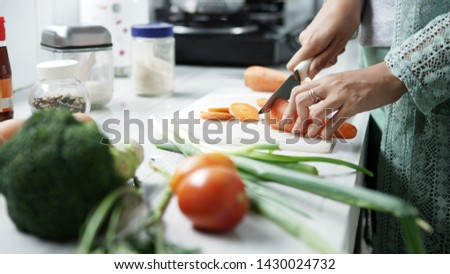                                
woman preparing vegetables for healthy meal and salad in a kitchen Royalty-Free Stock Photo #1430024732