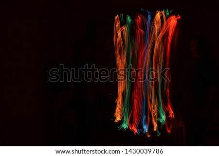 background, on a black background with bright colored spill light freezelight. Shine. Abstraction of light. magic