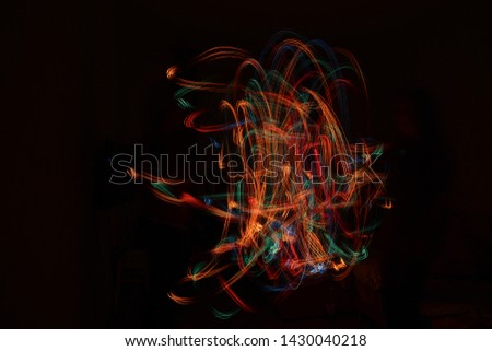 Photo background, on a black background with bright colored spill light freezelight. Shine. Abstraction of light. magic