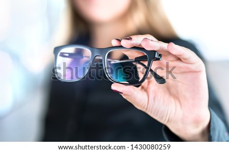 Optician, optometrist, oculist or eye doctor holding glasses and specs with new lenses. Professional eyesight specialist in clinic or shop with spectacles in hand. Bifocal or multifocal eyeglasses. Royalty-Free Stock Photo #1430080259