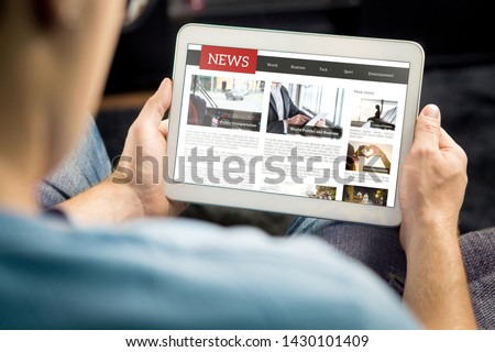 Online news article on tablet screen. Electronic newspaper or magazine. Latest daily press and media. Mockup of digital portal and website. Happy person using web service in the morning. Reading text. Royalty-Free Stock Photo #1430101409