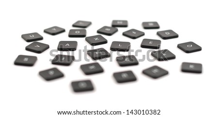 Scattered black keyboard button composition isolated over the white background, shallow depth of field