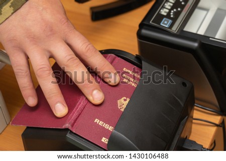 Devices for scanning passport documents, fingerprinting during border control of travelers. Automatic verification of personal data in databases. Biometric, identity verification, immigration concept Royalty-Free Stock Photo #1430106488