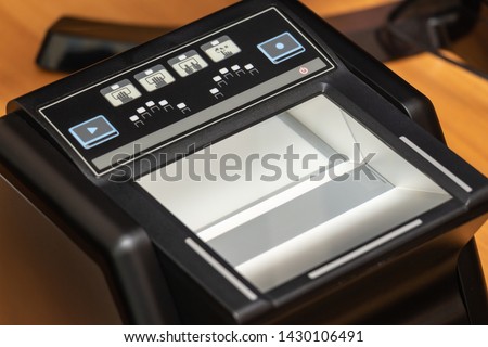 Devices for scanning passport documents, fingerprinting during border control of travelers. Automatic verification of personal data in databases. Biometric, identity verification, immigration concept Royalty-Free Stock Photo #1430106491
