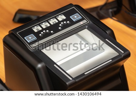 Devices for scanning passport documents, fingerprinting during border control of travelers. Automatic verification of personal data in databases. Biometric, identity verification, immigration concept Royalty-Free Stock Photo #1430106494