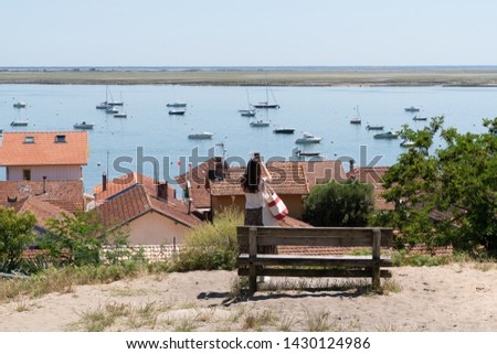 tourist young woman take phone picture in basin Cap Ferret Arcachon in french village Herbe