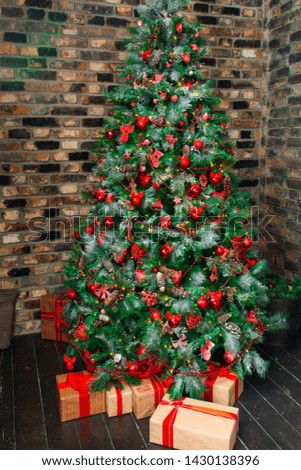 Merry Christmas!. Christmas tree with beautiful balls in brown interior. Against a brick wall. Christmas decor