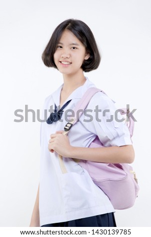 Portrait of Lovely Asian girl in school uniform with school bag on white background isolated