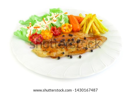 Grilled Fish Pangasius Fillet steak with barbecue sauce topped black peppers and salad decorate frenchfries and tomato carved style side view