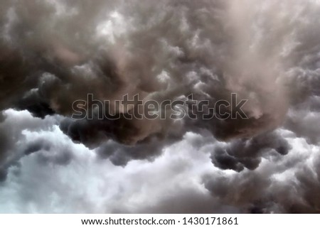 Very dark cloud formations of a heavy thunderstorm during sunset